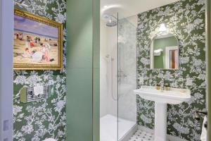 a bathroom with a sink and a shower at Villa Henriette in Cabourg