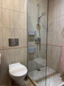 a bathroom with a toilet and a glass shower at Видовые 2-комнатное апартаменты в комплексе Varna South Bay in Asparukhovo +7 photos