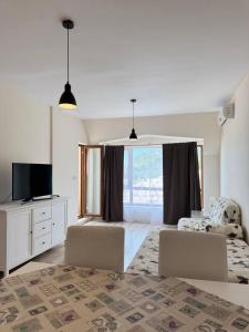 a living room with two chairs and a large window at Видовые 2-комнатное апартаменты в комплексе Varna South Bay in Asparukhovo