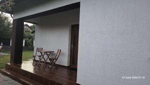 a patio with a table and chairs next to a building at Casa Magurele in Măgurele +8 photos