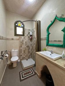 a bathroom with a sink and a toilet and a mirror at Haven Hills Chaouen in Chefchaouen +69 photos