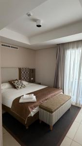 a bedroom with a large bed and a window at Radisson blu résidence alhcoeima in Al Hoceïma