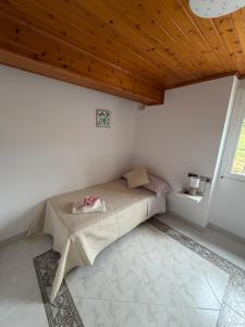 a bed in a room with a wooden ceiling at Casa Gallopin in Foz +9 photos