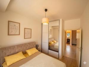 a bedroom with a bed and a mirror at Belvedere in Dobrota