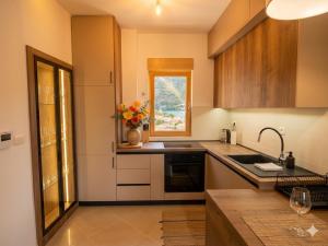 a kitchen with a vase of flowers on the counter at Belvedere in Dobrota