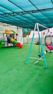 an empty playground with swings and other play equipment at فيلا in Salalah
