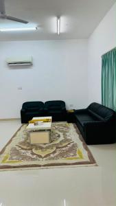 a living room with a couch and a coffee table at فيلا in Salalah