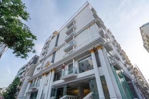 a large white building with columns at Hotel Narenn HITEC CITY in Hyderabad