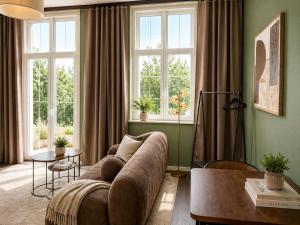 a living room with a couch and two windows at Schängel Chic 2 in Koblenz