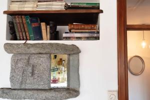 a fireplace with a book shelf with books at Vista Menaggio Centro by LoveComo in Menaggio