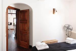 a room with a bed and a door with a fan at Vista Menaggio Centro by LoveComo in Menaggio +31 photos