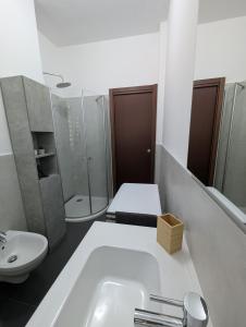 a bathroom with a sink and a shower and a toilet at Campesio Apartament in Piacenza