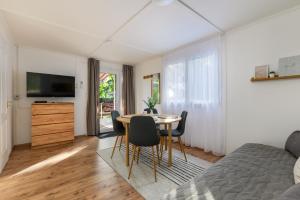 a bedroom with a bed and a table and chairs at Csendliget Apartman in Dunavarsány