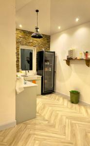 a bathroom with a shower and a wooden floor at Azure liwa in An Nashshāsh