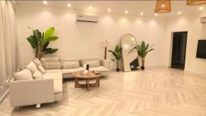 a living room with a couch and a table at Azure liwa in An Nashshāsh