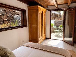 a bedroom with a bed and a sliding glass door at Villa Blanco - Romantic Hideaway - Private Villa for Couple in Tías