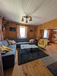 a living room with a couch and a table at Agroturystyka WROTA PODLASIA in Siemiatycze