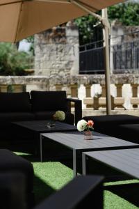 a patio with two tables and an umbrella at Château de Candes - Art & Spa in Candes-Saint-Martin +164 photos