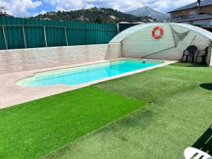 a small swimming pool in a backyard with a dome at La Casita de Eli in Becerril de la Sierra