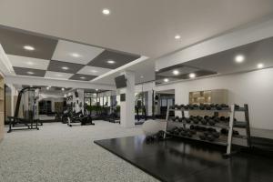 a room with a gym with a rack of weights at Courtyard by Marriott Manado in Manado