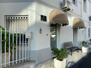 a white building with a bench outside of it at Affittacamere Sanbenedetto in San Benedetto del Tronto
