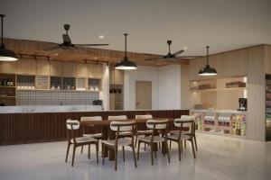 a dining room with a table and chairs at Courtyard by Marriott Manado in Manado