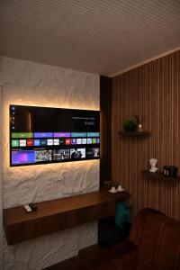 a television on a wall in a hotel room at Feli Lodge in Bosanska Gradiška