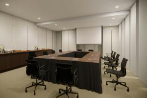a conference room with a large table and chairs at Courtyard by Marriott Manado in Manado +34 photos