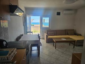 a living room with a couch and a table at Apartmani Marko in Nin