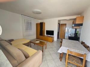 a living room with a couch and a table at Apartmani Marko in Nin