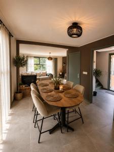 a dining room with a table and chairs at Ecolodges De Dreef Guesthouse in Renesse
