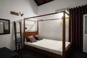 a bed with a canopy in a room at Enderamulla Casual Home in Wattala