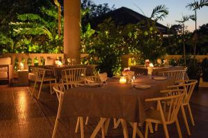a restaurant with tables and chairs with lights on them at Stunning Oceanfront 4-Bdrm Villa w/ Infinity Pool in San Lorenzo