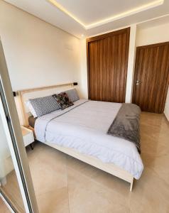 a bedroom with a large white bed in a room at Le Ramo - Résidence Ramoflores in Sidi Rahal +12 photos