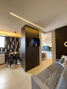 a living room with a couch and a dining room at Studio Luxuoso com vista surpreendente in Macapá