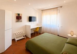 a hotel room with a bed and a desk at GV Apartments in Caserta