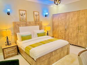a bedroom with a large bed and two lamps at Green Paradise Hotel in Mogadishu