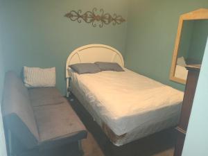 a bedroom with two beds and a mirror at ARMANI MANOR rustic spacious 2br unit 1 in Wildwood