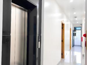 a hallway with black and white walls and a glass door at HagiangTrips Hotel in Ha Giang