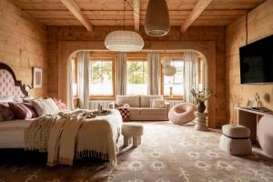 a bedroom with a bed and a living room at Owca na Polanie in Zakopane