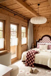 a bedroom with a bed and a wooden wall at Owca na Polanie in Zakopane