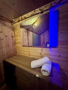 a sauna with a white towel on a wooden wall at Flori's House in Valbonë