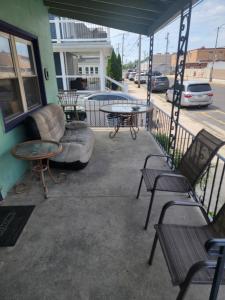 a patio with tables and chairs on a building at ARMANI MANOR rustic spacious 2br unit 1 in Wildwood