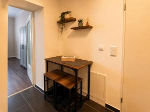 a small table with two stools in a room at Schängel Chic 03 in Koblenz