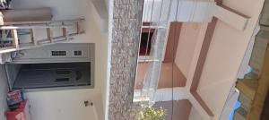 a view of a room with a tv and a staircase at ArsonGuest in Berat