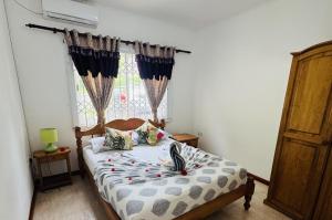 a bedroom with a bed in front of a window at Haus Megan in Mahe