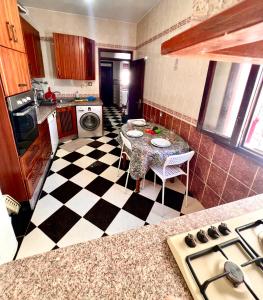 a kitchen with a black and white checkered floor at Blue Pearl city in Chefchaouen