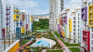 an apartment complex with a swimming pool and buildings at My Sweet Apartment in Tbilisi City