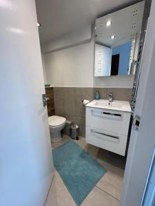 a bathroom with a white sink and a toilet at Birch Tree House in Windermere +16 photos
