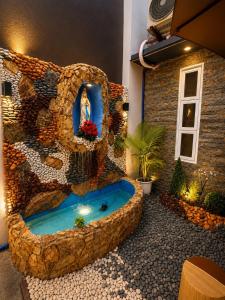 a bathroom with a fountain in the middle of a room at Zenith Haven Casa de Padrillos in Imus